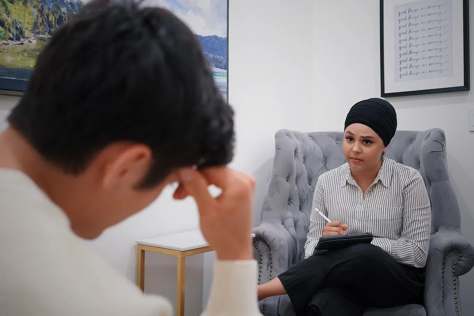 Therapist having a counseling session with a patient in a serene office setting.