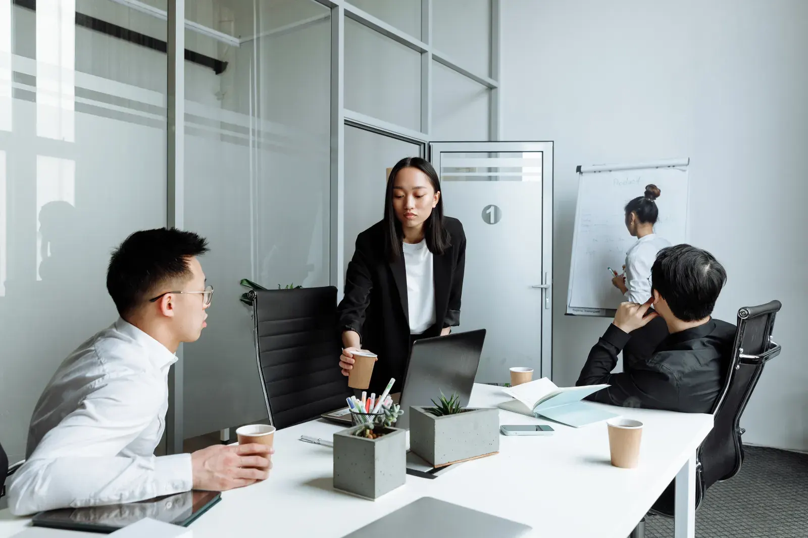 Diverse office team engaged in a collaborative meeting discussing business strategies.