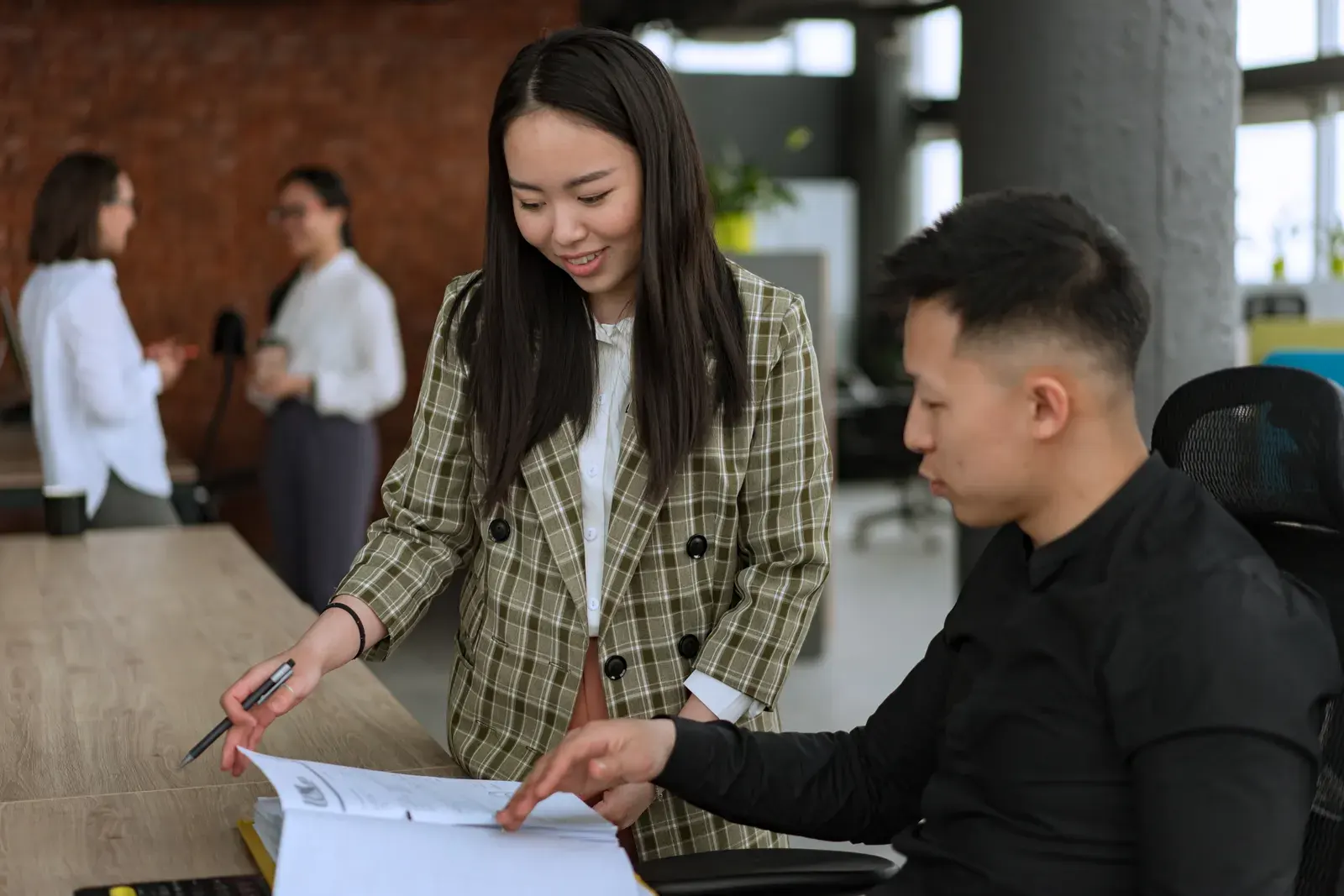 Business team collaborating on a project in a modern office setting.