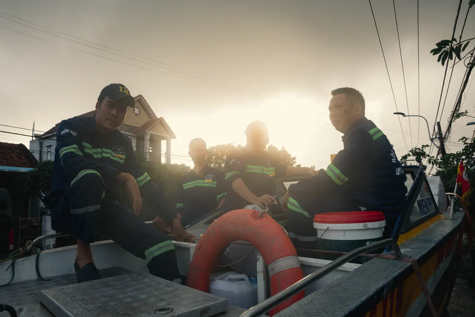 Rescue workers in uniform on a boat at sunset in Phú Yên, Vietnam